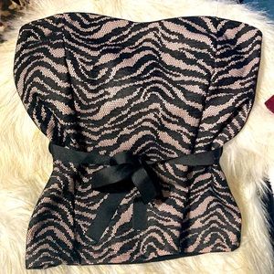 A black and pink laced strapless top with a string tied in a bow or as you wish